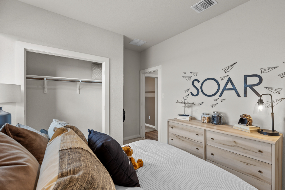 A room with a bed and a desk.