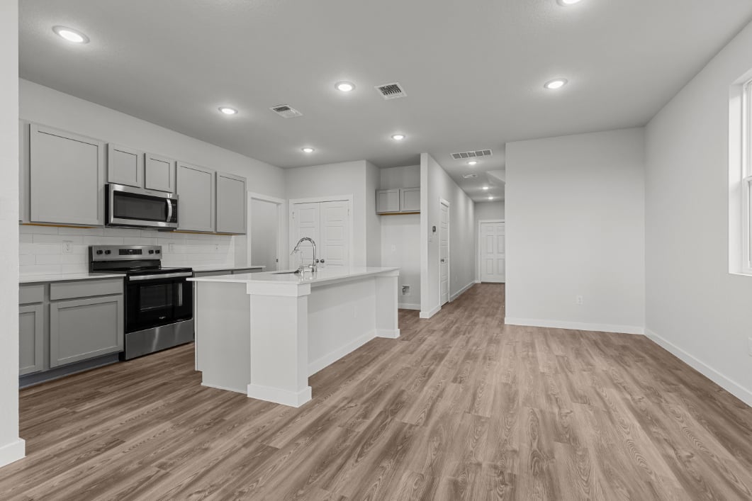 A kitchen with white cabinets.