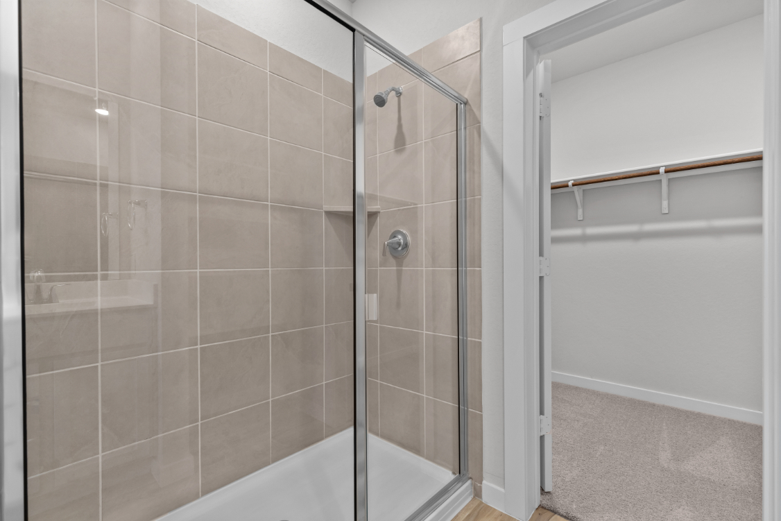 A shower with a glass door.