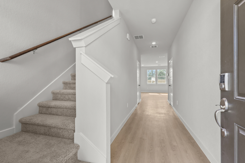 A hallway with white walls.