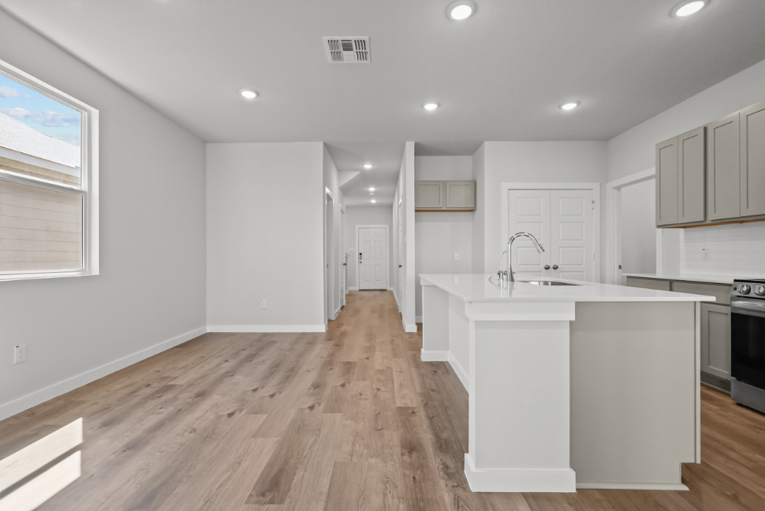 A kitchen with white cabinets.