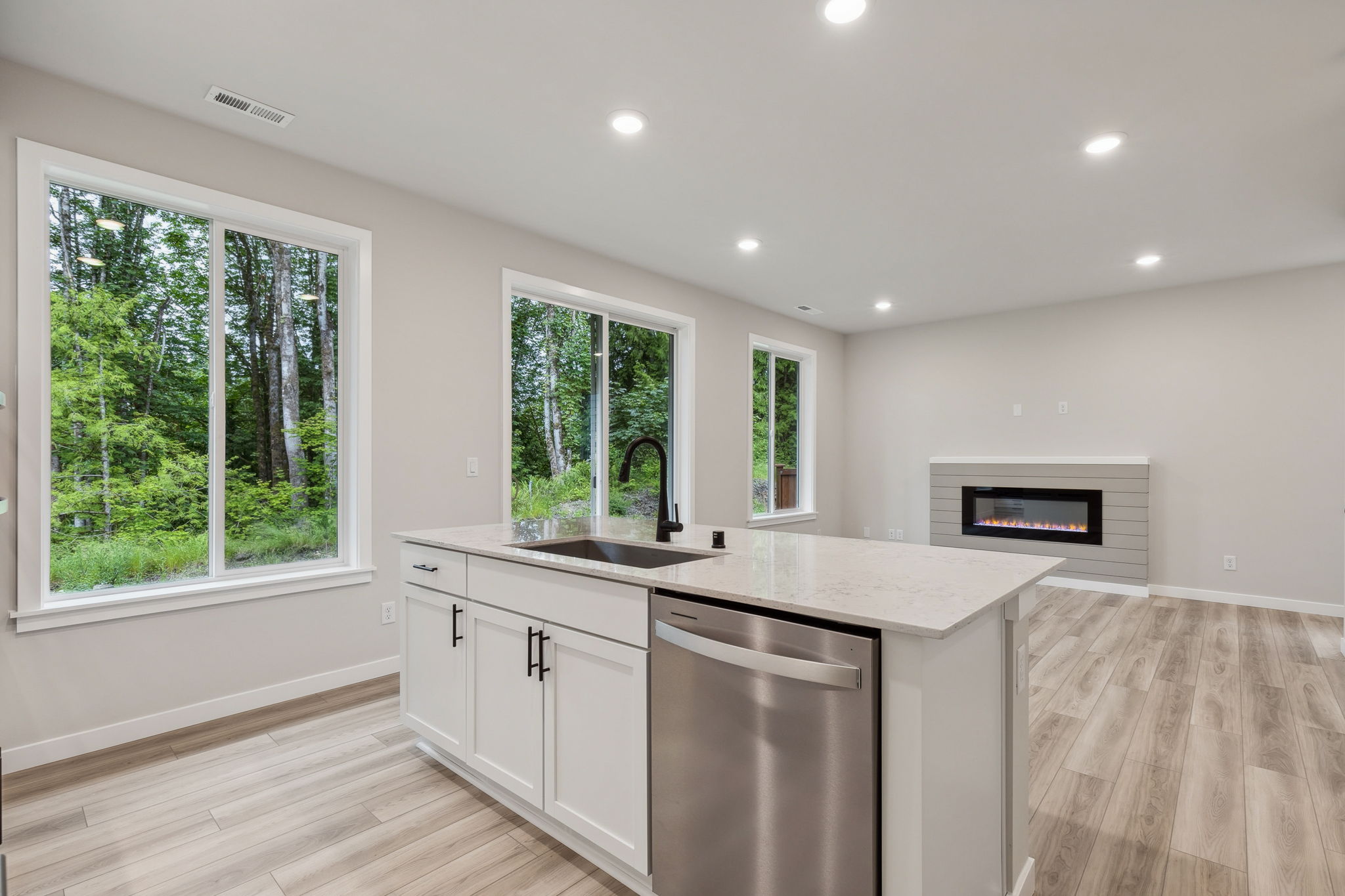 A kitchen with a stove and a microwave.