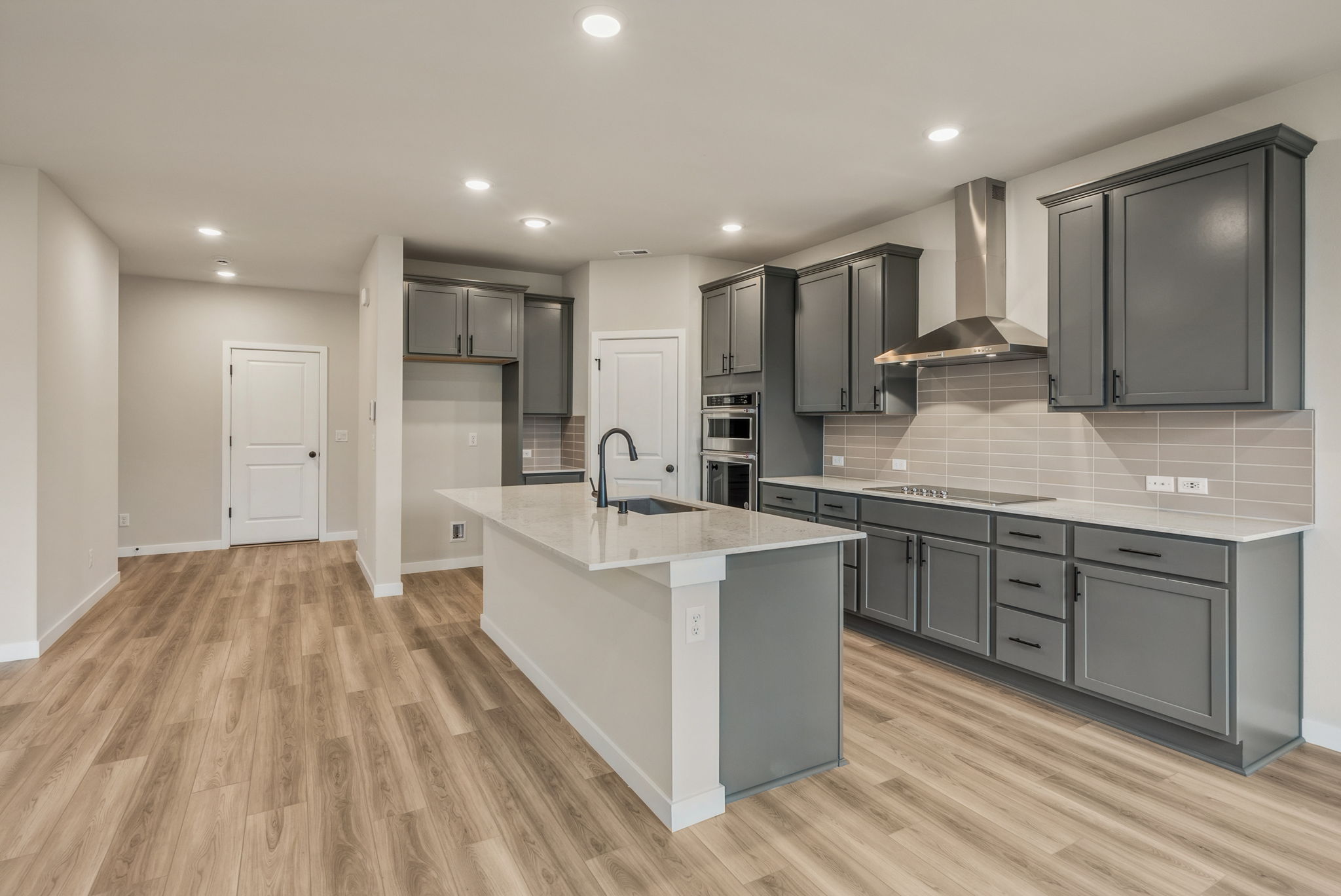 A kitchen with black cabinets.