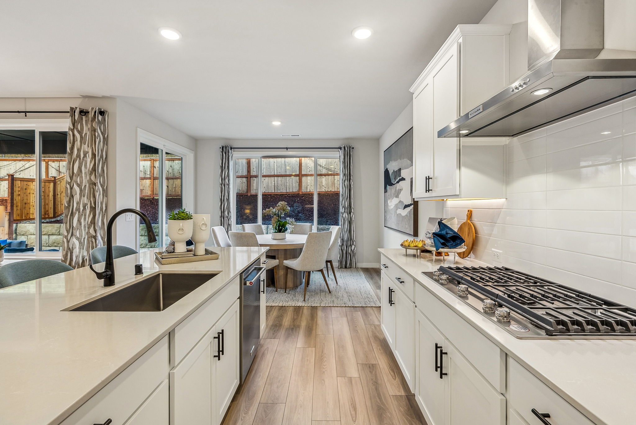 A kitchen with white cabinets.