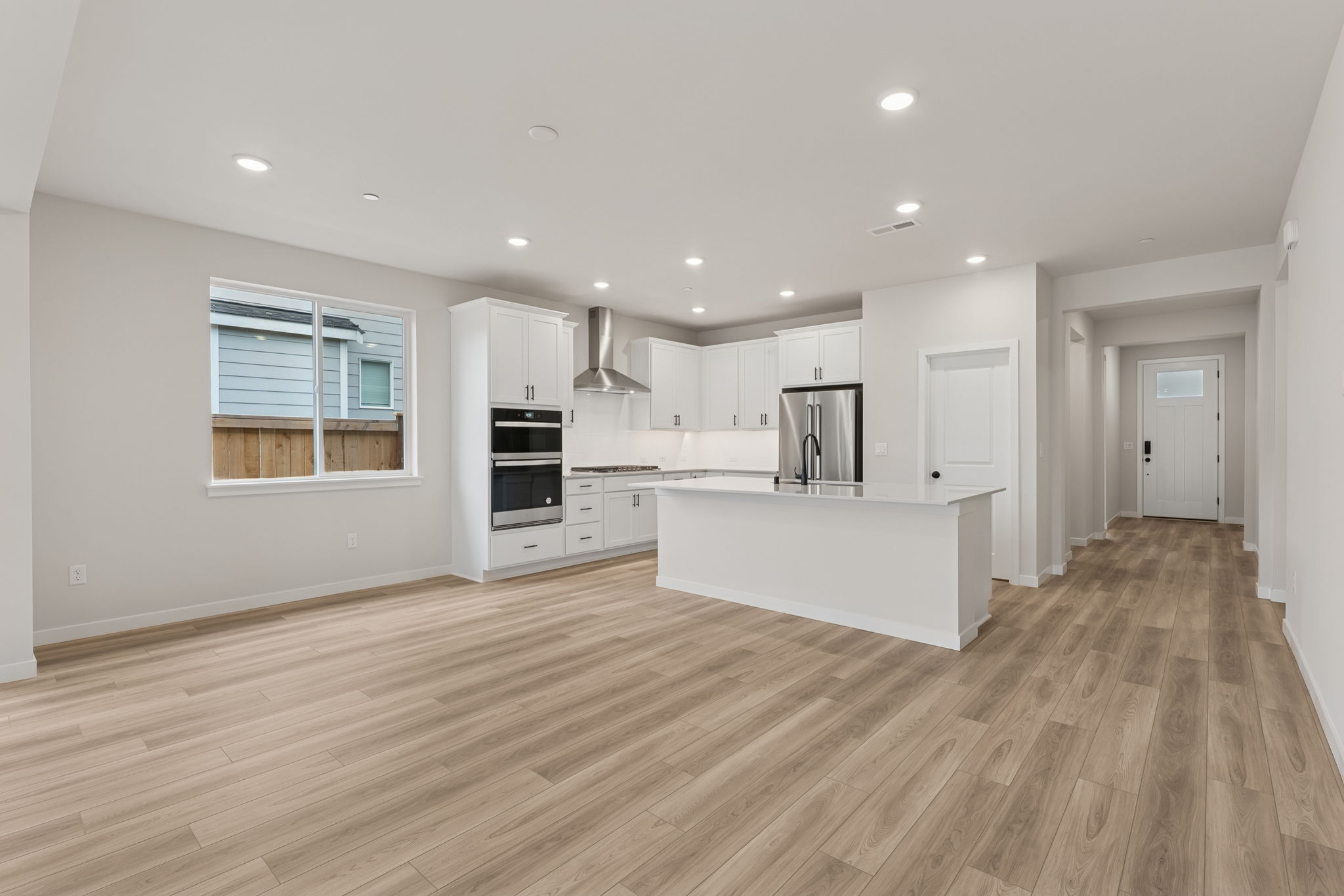 A kitchen with white cabinets.