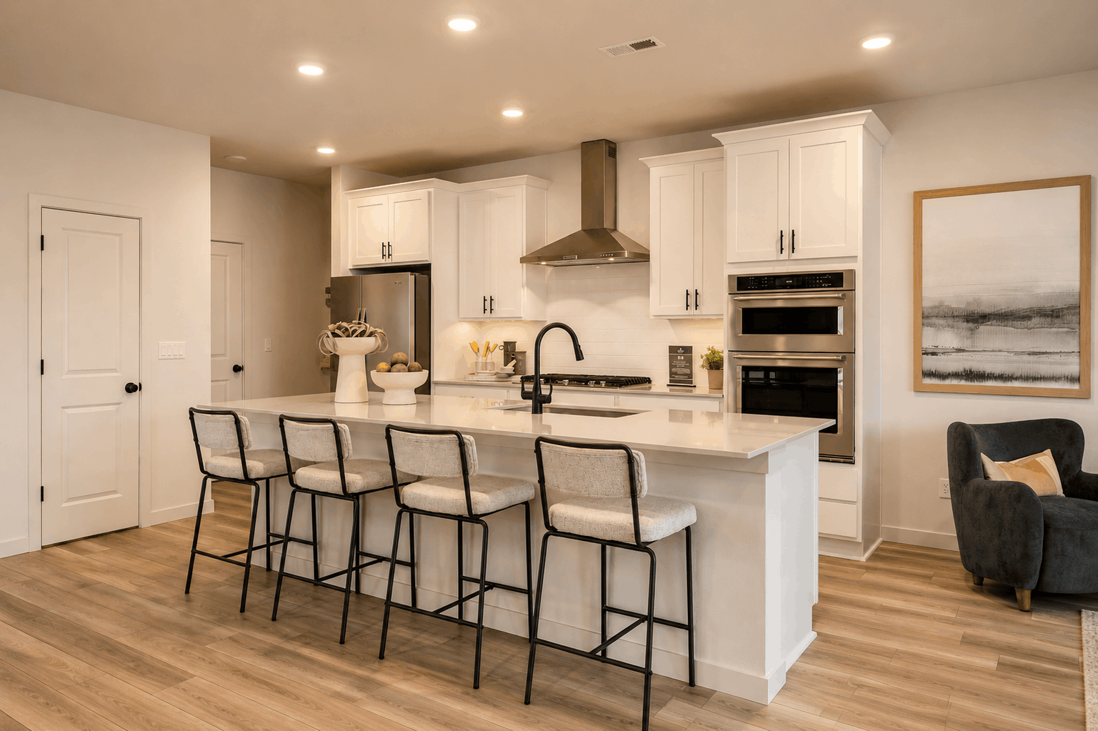 A kitchen with a dining table and chairs.
