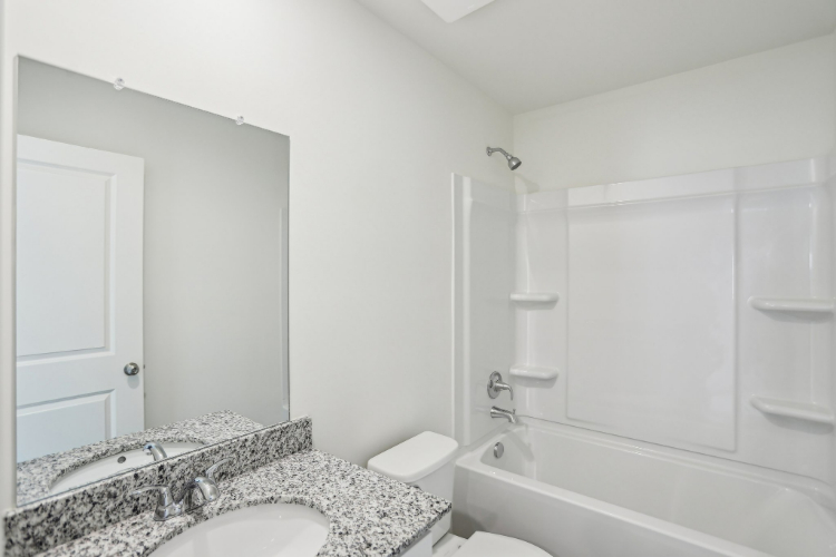 A bathroom with a marble countertop.