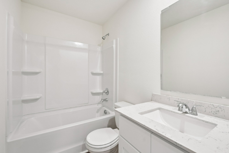 A bathroom with a sink toilet and bathtub.
