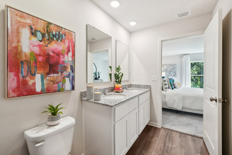 A bathroom with a large mirror.