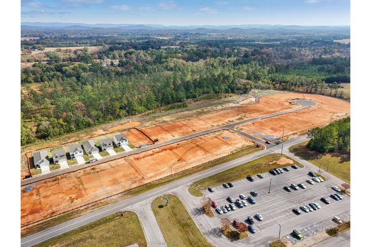 A parking lot with cars and trees.