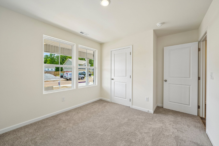 A room with white doors and a window.