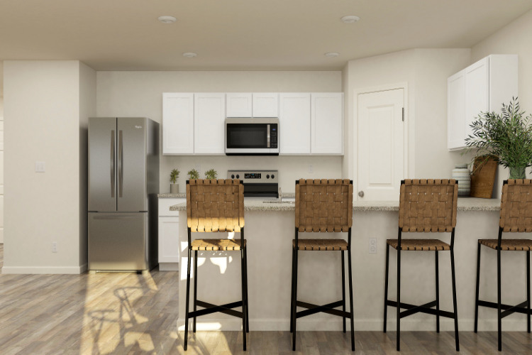 A kitchen with white cabinets.