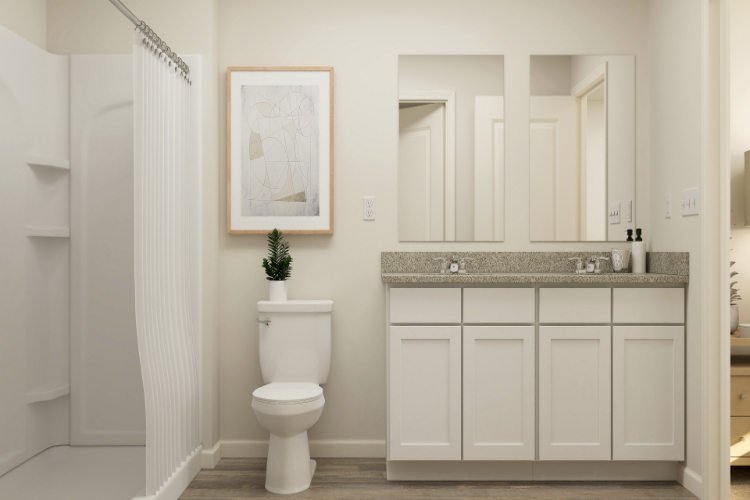 A bathroom with white cabinets.
