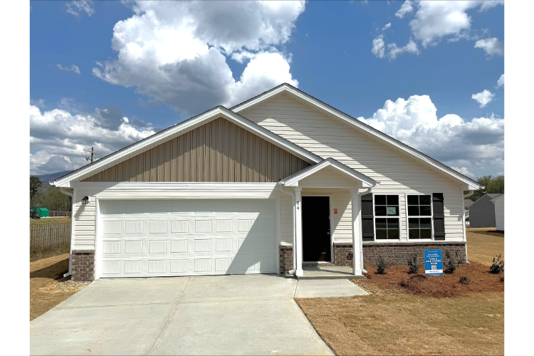 A white house with a garage.