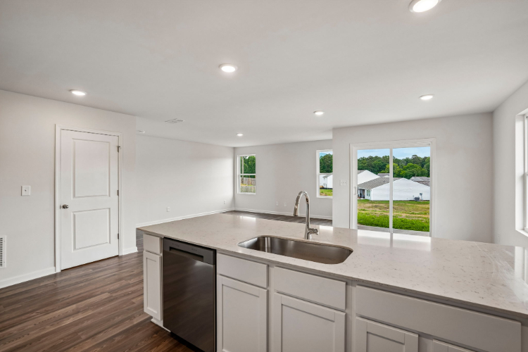 A kitchen with a large window.