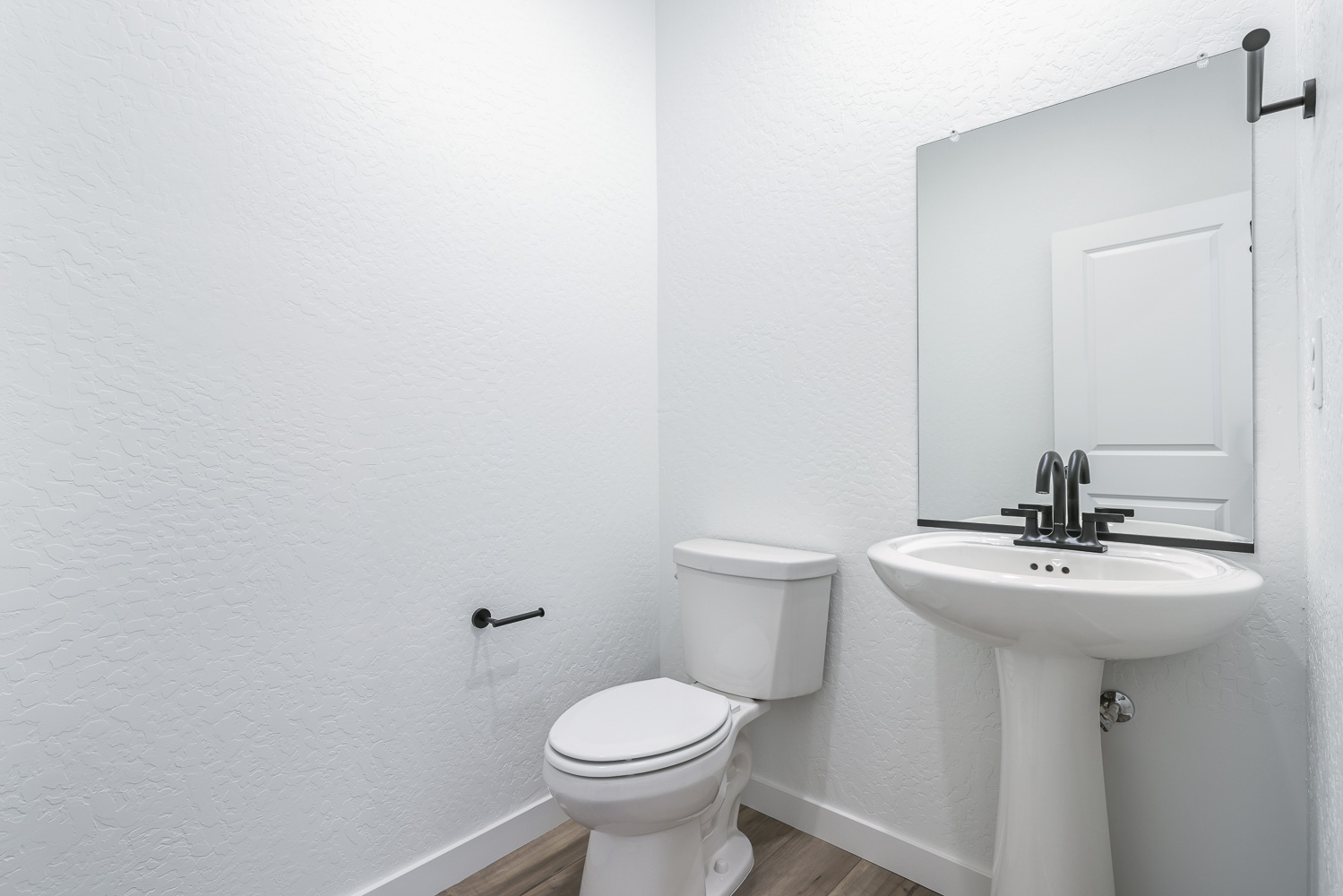 A bathroom with a toilet and sink.