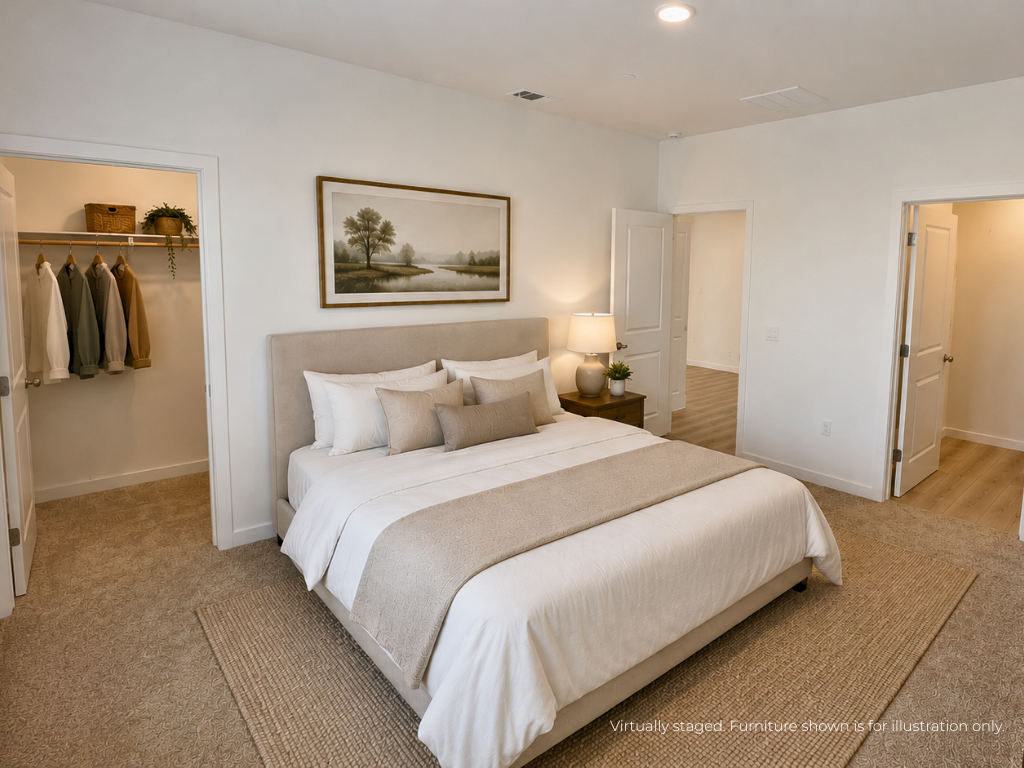 A bedroom with a bed and a lamp.