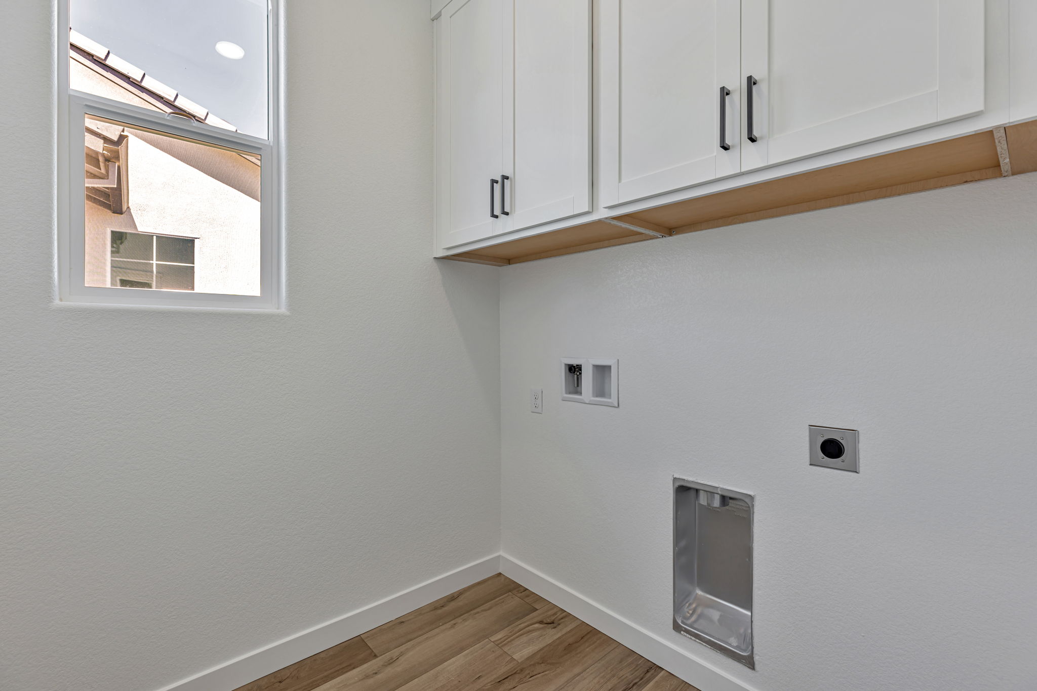 A white wall with a window.