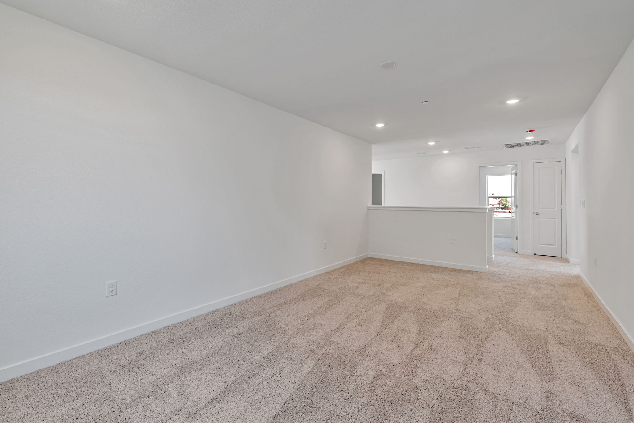A long hallway with white walls.